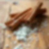 Cinnamon sticks with a sprinkle of sugar on a wooden surface