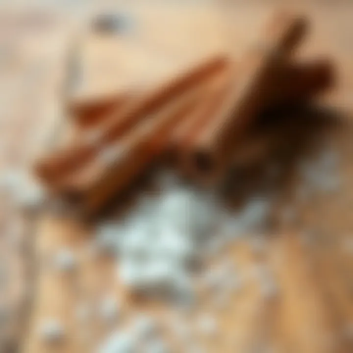 Cinnamon sticks with a sprinkle of sugar on a wooden surface